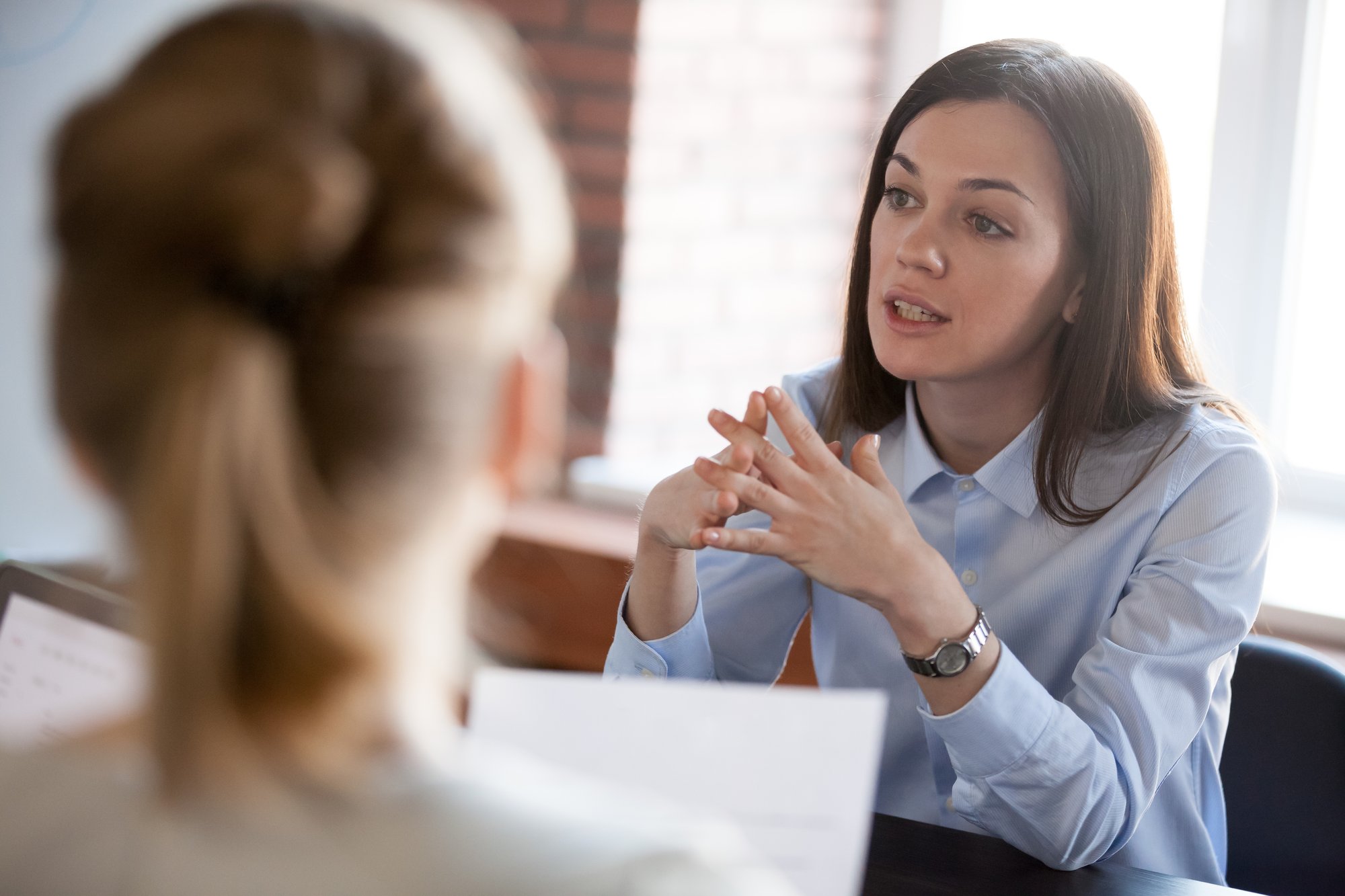 Legal professional consulting with a client regarding administrative defense proceedings.