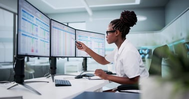 woman pointing at computer screen