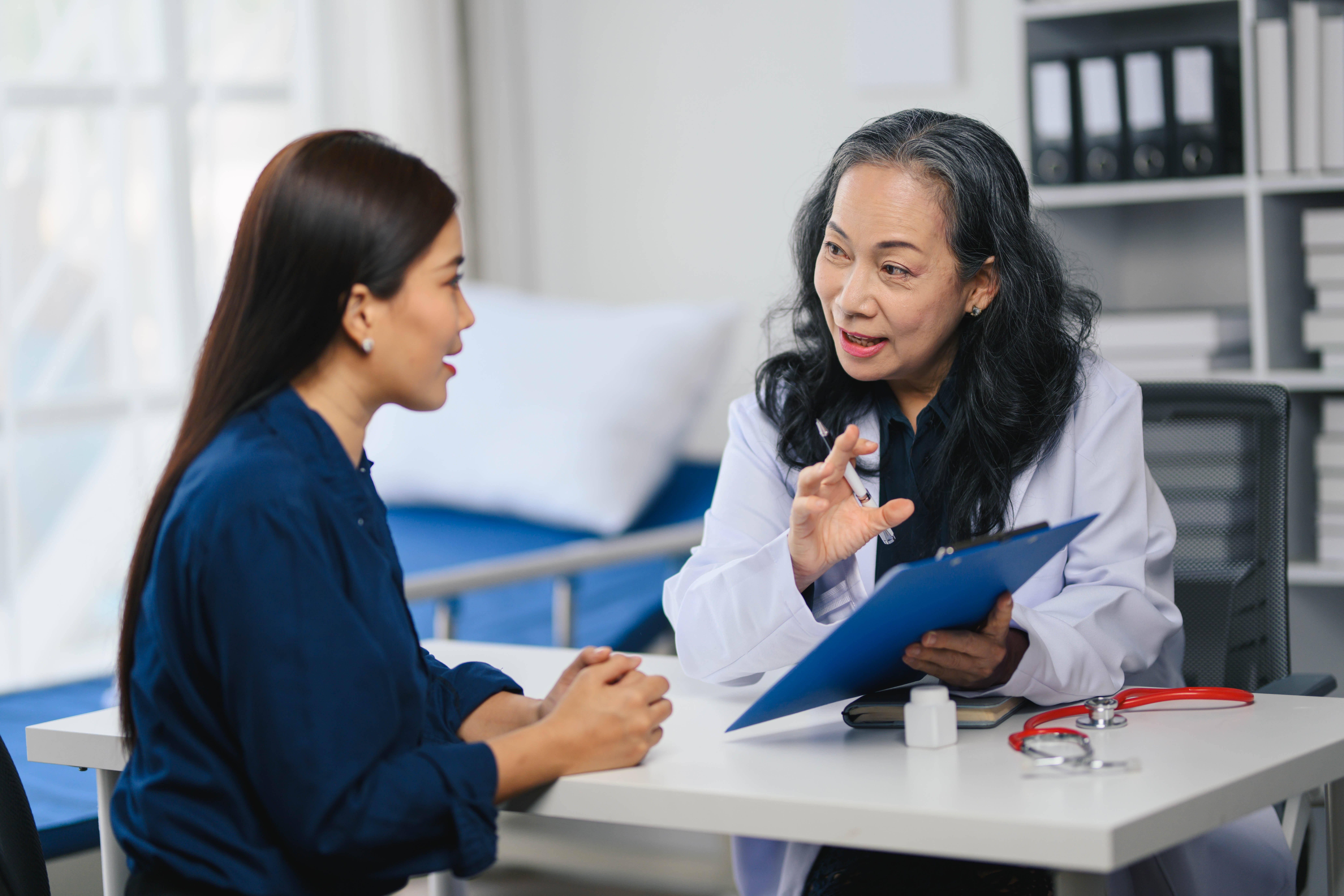 Healthcare provider discussing treatment options and informed consent with a patient during an office consultation.