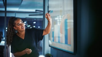 african american woman pointing at charts