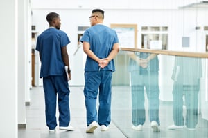 two podiatrists walking next to each other talking