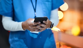Podiatrist holding a phone texting a patient