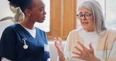 podiatrist looking empathetically at an upset patient