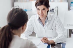 female podiatrist looking at patient